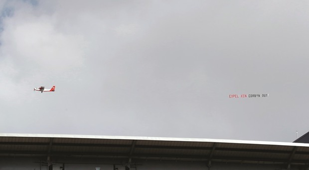 A plane flies over Wembley Stadium displaying the message u201cexpel ken Corbyn outu201d