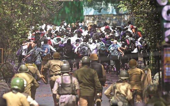 Government forces try to chase Kashmiri students during clashes in central Srinagaru2019s Lal Chowk yesterday.