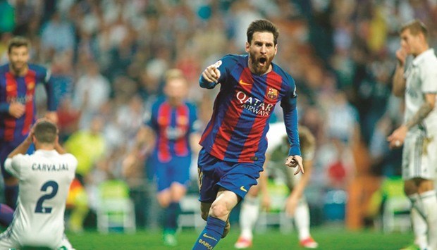 Barcelonau2019s Argentinian forward Lionel Messi celebrates after scoring during the Spanish league Clasico match against Real Madrid at the Santiago Bernabeu stadium.