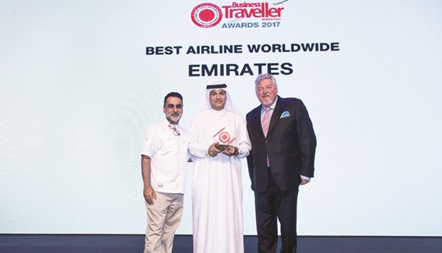 Al-Redha (centre) receiving the Best Airline Worldwide award from Ian Fairservice (right), managing partner and group editor, Motivate Publishing, and chef Vineet Bhatia at the 2017 Business Traveller Awards.