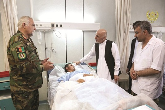 Afghanistanu2019s President Ashraf Ghani visits a victim wounded in April 21u2019s attack on an army headquarters, in Mazar-i-Sharif, northern Afghanistan.