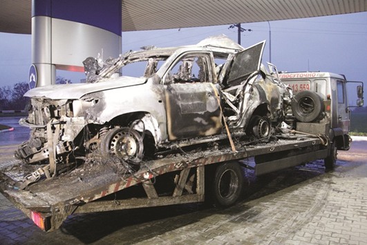 The damaged vehicle that drove over a mine while transporting members of the OSCE who were killed and injured from the incident on Sunday, is seen at a petrol station while it is moved from the blast site in the Luhansk region.