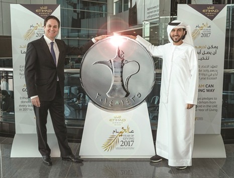 Peter Baumgartner and Mohamed al-Bulooki launch Etihad Airwaysu2019 dirham donation pledge.
