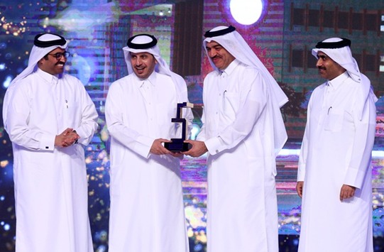 HE the Prime Minister and Interior Minister Sheikh Abdullah bin Nasser bin Khalifa al-Thani presenting the award for the Ministry of Municipality and Environment to HE the Minister Mohamed bin Abdullah al-Rumaihi as HE the Minister of Energy and Industry Dr Mohamed bin Saleh al-Sada and Kahramaa president and senior engineer Essa bin Hilal al-Kuwari look on. PICTURE: Jayaram