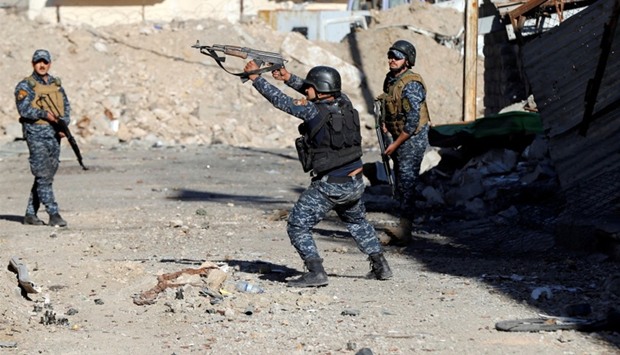 Members of the Iraqi Federal Police clash with the Islamic State fighters in western Mosul