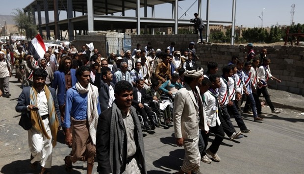 Yemeni men take part in a ,protest for bread, march from the capital Sanaa to the coastal town of Hodeida on April 19.