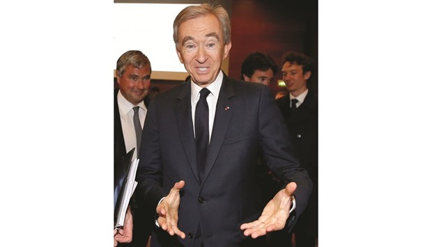 Chairman and CEO of Luxury goods group LVMH Bernard Arnault gestures after a news conference to announce a deal to simplify Christian Dior business structure in Paris yesterday.