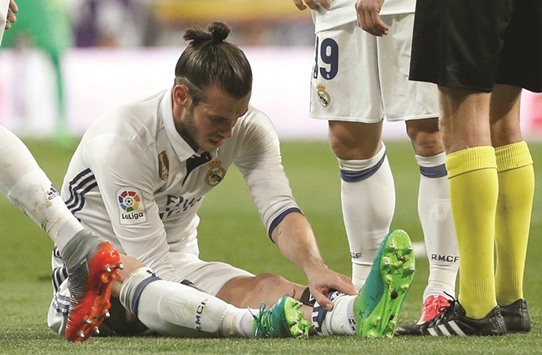 File picture of Real Madridu2019s Gareth Bale sitting on the pitch after injuring his calf during the El Clasico at the Santiago Bernabeu in Madrid, Spain.