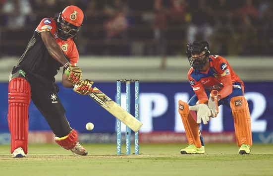 Chris Gayle (left) has become the first batsman to accumulate 10,000 Twenty20 runs, going past the milestone during a match-winning blitz for Royal Challengers Bangalore against Gujarat Lions in the Indian Premier League last week. (AFP)