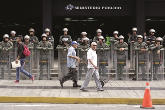 Venezuelan National Guard members stand guard in front of Venezuelau2019s prosecutor office in Caracas, Venezuela, yesterday.