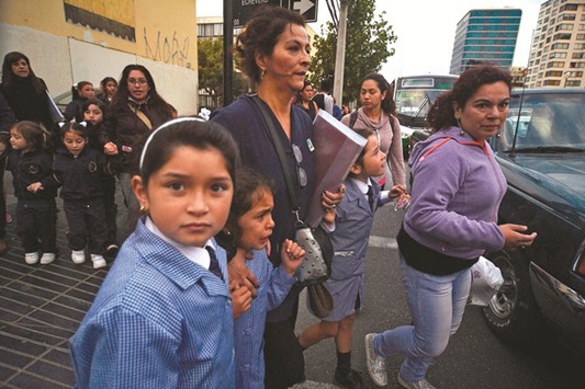 Women and schoolchildren evacuate a building during the quake in Vina del Mar, Chile.