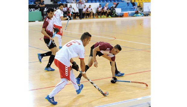 Iranu2019s Hamid Noraniyan (second from right) tries to go past Qataru2019s Mohamed Sami Ullah (right) during their menu2019s Indoor Asia Cup Hockey match at Aspire Dome yesterday. PICTURE: Ram Chand
