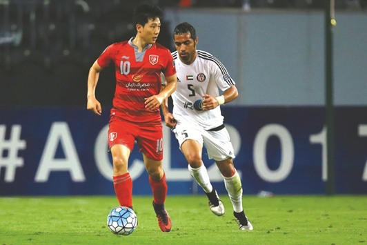 Lekhwiyau2019s South Korean midfielder Nam Tae-hee (L) dribbles past Jazirau2019s Emirati defender Musallem Fayez during their AFC Champions League group B football match at the Mohammed Bin Zayed stadium in Abu Dhabi yesterday.
