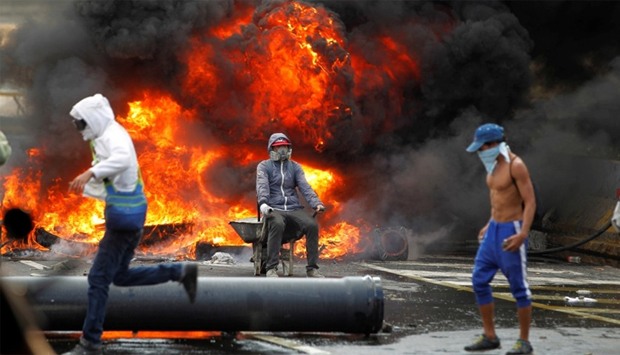 Demonstrators build a fire barricade on a street during a rally against Venezuela's President Nicolas Maduro in Caracas