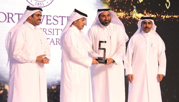 HE the Prime Minister and Interior Minister Sheikh Abdullah bin Nasser bin Khalifa al-Thani presenting QFu2019s senior engineer Jassim Telefat with an award at the fifth annual Tarsheed awards ceremony as HE the Minister of Energy and Industry Dr Mohamed bin Saleh al-Sada and Kahramaa president Essa bin Hilal al-Kuwari look on.