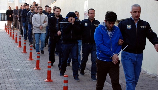 Suspected supporters of the US-based cleric Gulen are escorted by plainclothes police officers