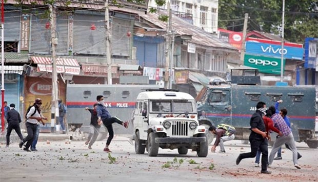 Kashmiri protesters hurl stones towards police vehicles in Srinagar this week.