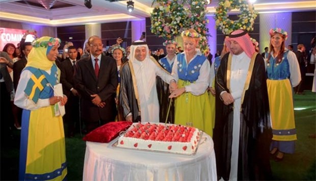 HE the Minister of Education and Higher Education Mohamed Abdul Wahed Ali al-Hammadi and Swedish ambassador Ewa Polano lead the ceremonial cake cutting while other dignitaries look on during the celebration of Sweden's National Day. PICTURE: Ibrahim al-Muftah.