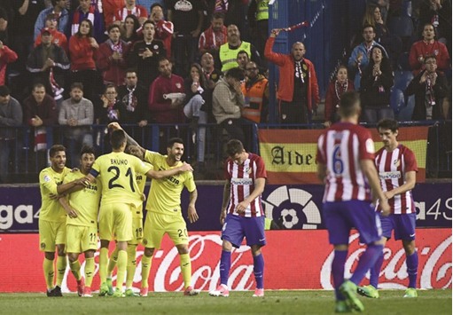 Villarrealu2019s players celebrate a goal against Atletico Madrid.