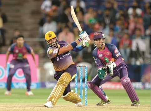 Kolkata Knight Ridersu2019 Robin Uthappa (left) plays a shot as Rising Pune Supergiants wicketkeeper Mahendra Singh Dhoni looks on during the Indian Premier League match in Pune yesterday. (AFP)
