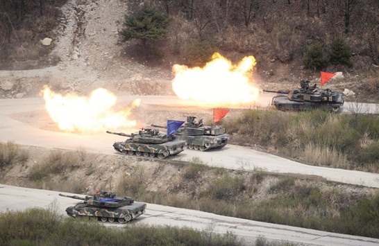 South Korean Army K1A1 and US Army M1A2 tanks fire live rounds during a US-South Korea joint live-fire military exercise at a training field near the demilitarised zone in Pocheon, South Korea.