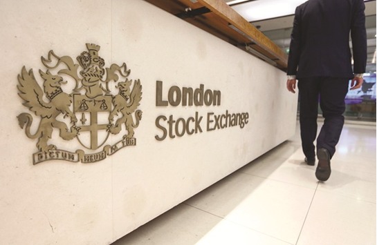 A visitor passes a sign at the London Stock Exchange Groupu2019s offices in Paternoster Square. The FTSE 100 closed 0.2% up at 7,288.72 points yesterday.