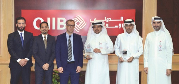 Al-Shaibei with al-Jamal and Arjouz among senior QIIB and Visa executives during the award distribution in Doha.