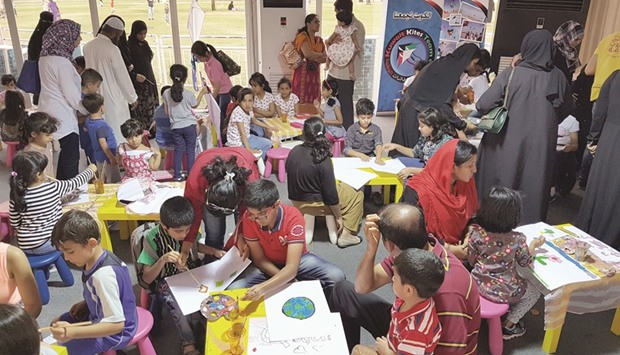 Children draw and decorate their kites. PICTURE: Joey Aguilar