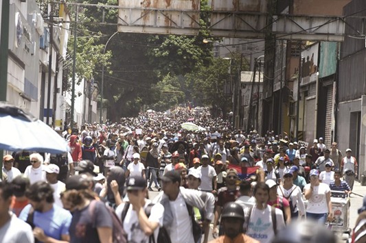 Opposition demonstrators march in Caracas yesterday.