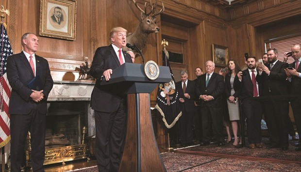 US Secretary of the Interior Ryan Zinke listens while US President Donald Trump speaks before signing the executive order.