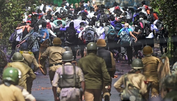 Indian government forces  chase Kashmiri students during clashes
