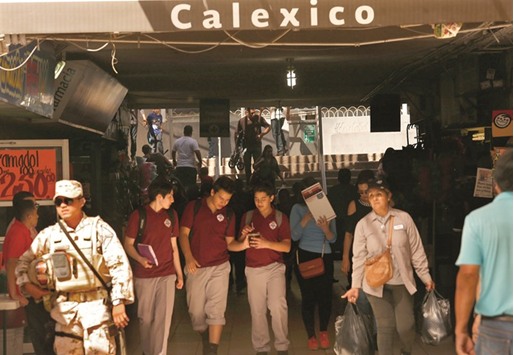 TOUGHING IT OUT: At the end of a school day, Calexico Mission School students, in school uniforms, cross the border to Mexicali, Mexico, where they live.
