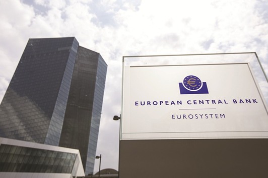 A euro currency symbol sits on a eurosystem sign outside the the European Central Bank (ECB) headquarters in Frankfurt. The ECB maintained its bias for further policy easing yesterday, leaving the door open to further rates cuts or an increase in asset buys.