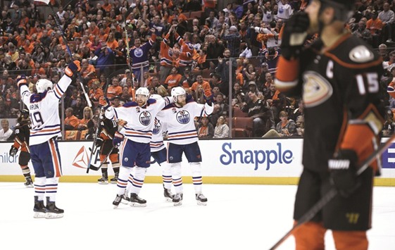 Edmonton Oilers players celebrate a goal against the Anaheim Ducks during the third period.