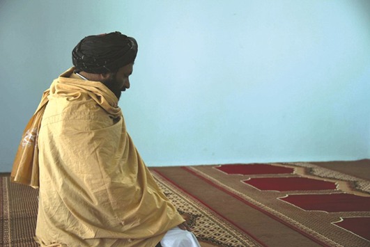 In this photograph taken on March 22, 2017, former Afghan Taliban commander Maulvi Abdul Rauf, 37, offers prayers inside a mosque in the Panjwayi district of Kandahar Province. An Afghan strongman is giving sanctuary to Taliban fighters and their families who have sought haven across the border in Pakistan, building on a radical strategy to reduce Islamabadu2019s perceived influence on the insurgency.