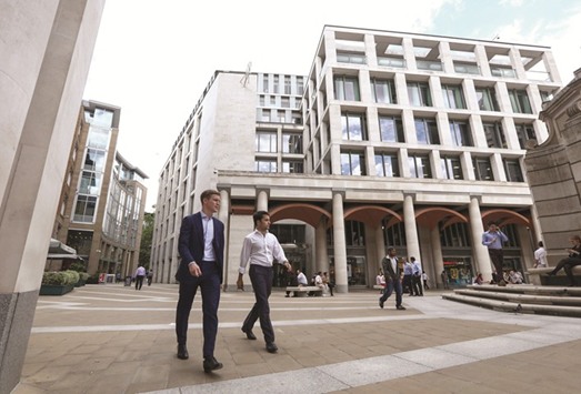 Pedestrians pass the London Stock Exchange Group offices in Paternoster Square. The FTSE 100 was 0.7% down at 7,237.17 points at close yesterday.