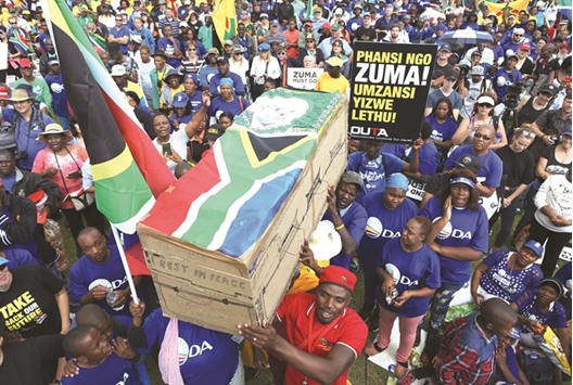 People hold a mock-coffin bearing the national flag and the face of Zuma during a rally organised yesterday by the newly formed u2018Freedom Movementu2019, which comprises of opposition parties, religious community and civil society, at Caledonian Stadium in Pretoria.