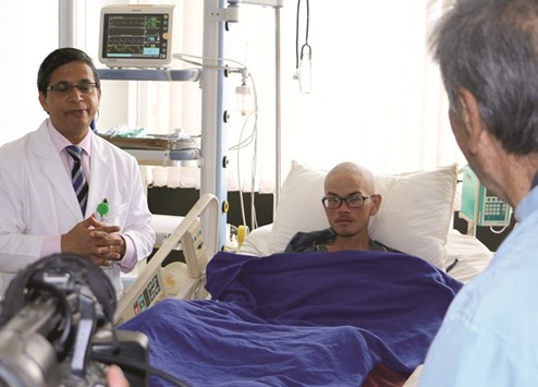 Taiwanese trekker Liang Sheng-yueh , who was rescued alive after being stranded in the Himalayas for 47 days, talks with a Nepalese doctor at a hospital in Kathmandu. The Taiwanese trekker is recovering in hospital after rescuers found him and his dead girlfriend on a mountainside in Nepal where they were stranded for 47 days.