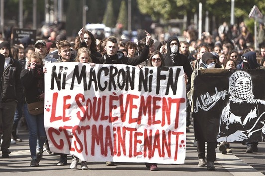 Protesters hold a banner reading u2018Neither Macron nor FN, the uprising is nowu2019 during a demonstration yesterday in Nantes, western France, against the results of the first round of the French presidential election.