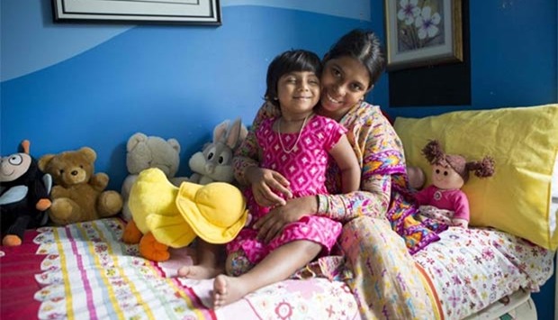 Three-year-old Choity Khatun is seen with her mother Shima in a hospital in Melbourne after she had life-saving reconstructive surgery. 