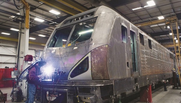 An employee grinds the metal frame of an Amtrack locomotive at the Siemens Industry manufacturing facility in Sacramento, California. In Hoboken, a u201cworn and chippedu201d track switch remained in use more than three months after it was identified, according to documents that New Jersey Transit provided.