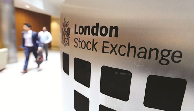 Visitors pass a sign inside the main atrium of the London Stock Exchange Groupu2019s (LSE) headquarters. The FTSE 100 closed 0.5% down at 7,203.94 points yesterday.