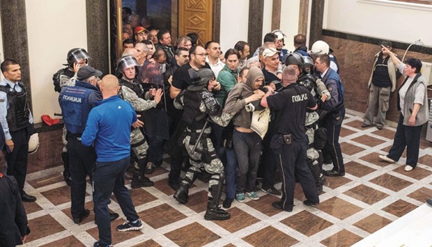 This picture taken on Thursday evening shows police officers try to prevent protesters from storming Macedoniau2019s parliament.