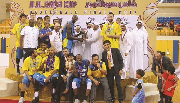 Al Gharafa players and officials celebrate with the Emir Cup trophy after beating El Jaish in the final yesterday. PICTURES: Othman Iraqi