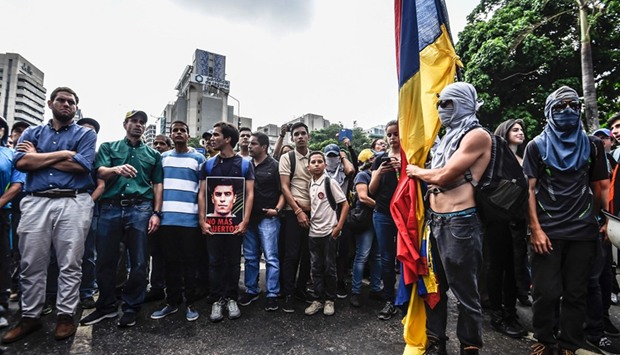 Venezuelan opposition leader Henrique Capriles takes part in a march yesterday paying tribute to student Juan Pablo Pernalete who was killed by the impact of a gas grenade during a protest against President Nicolas Maduro in Caracas on Thursday.