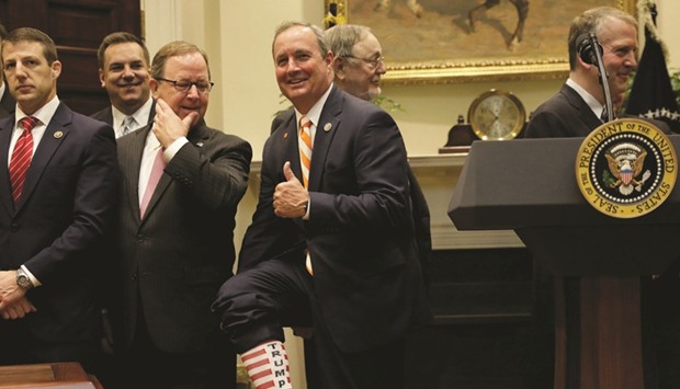 Rep. Jeff Duncan (R-SC) reveals a Trump sock at an event where President Trump signed an executive order to expand drilling for oil.