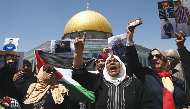Families of Palestinians imprisoned in Israeli jails demonstrate outside the Dome of the Rock at the Al-Aqsa mosque compound in Jerusalemu2019s Old City yesterday.