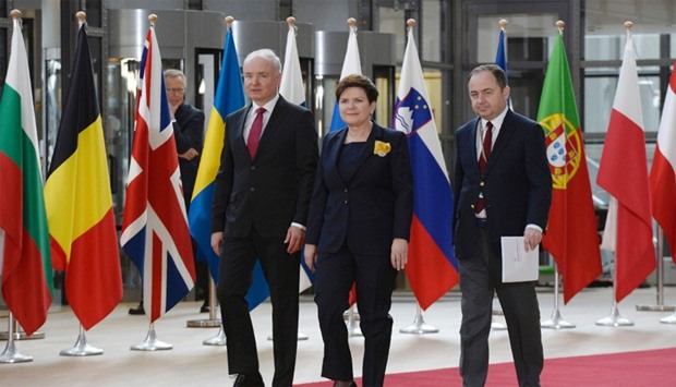 Poland's Prime minister Beata Szydlo (C) arrives to take part in the EU leaders summit