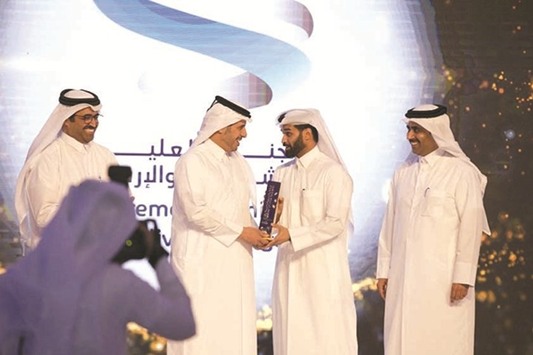 HE the Prime Minister and Interior Minister Sheikh Abdullah bin Nasser bin Khalifa al-Thani presenting the award to SC secretary-general Hassan al-Thawadi as HE the Minister of Energy and Industry Dr Mohamed bin Saleh al-Sada and Kahramaa president Essa bin Hilal al-Kuwari look on.