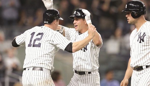 New York Yankees center fielder Jacoby Ellsbury (centre) celebrates his grand slam against the Baltimore Orioles with third baseman Chase Headley (left) and left fielder Matt Holliday (right) during the game at Yankee Stadium in Bronx, New York, on Friday. (USA TODAY Sports)